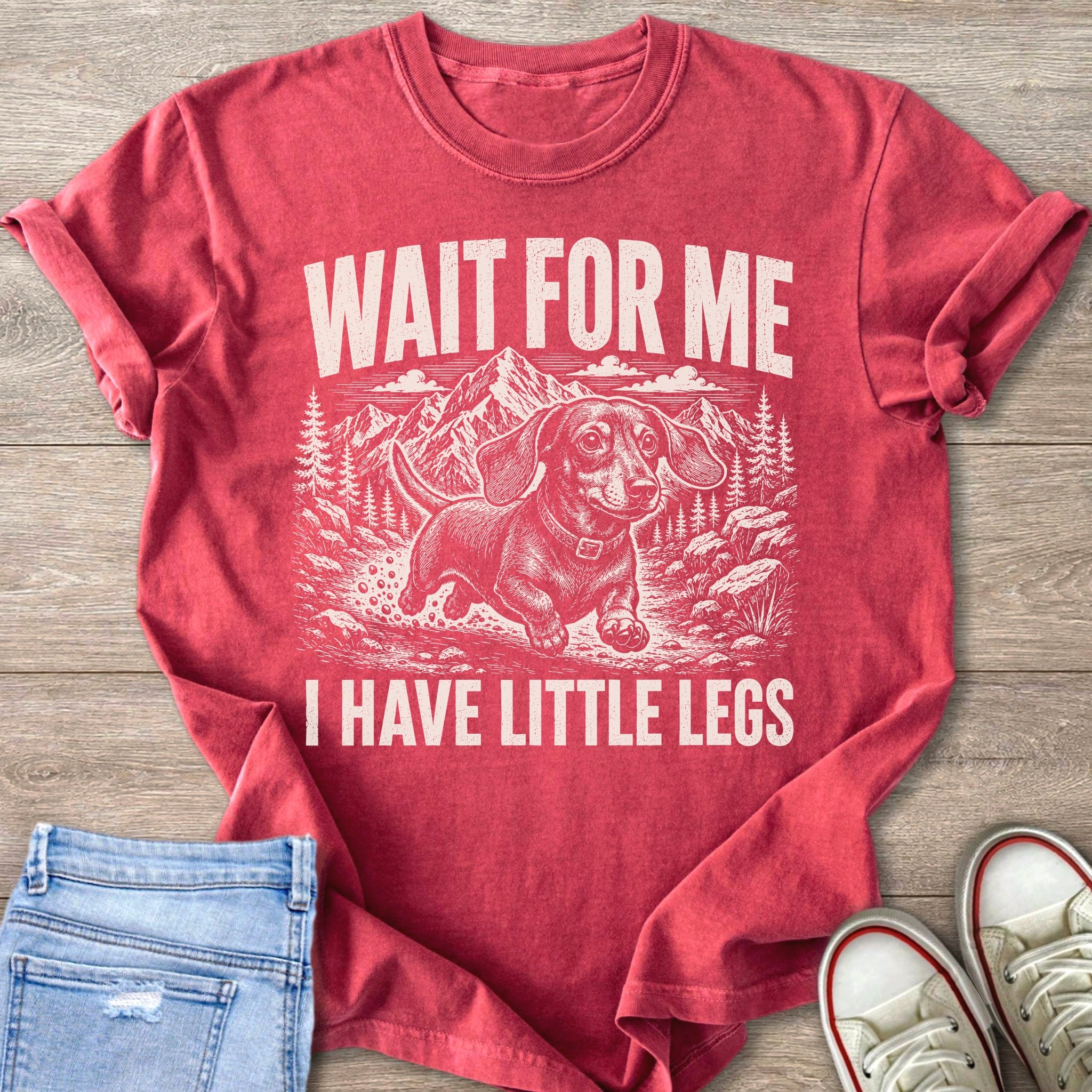 Red t-shirt with white text "WAIT FOR ME I HAVE LITTLE LEGS" and a dachshund graphic.