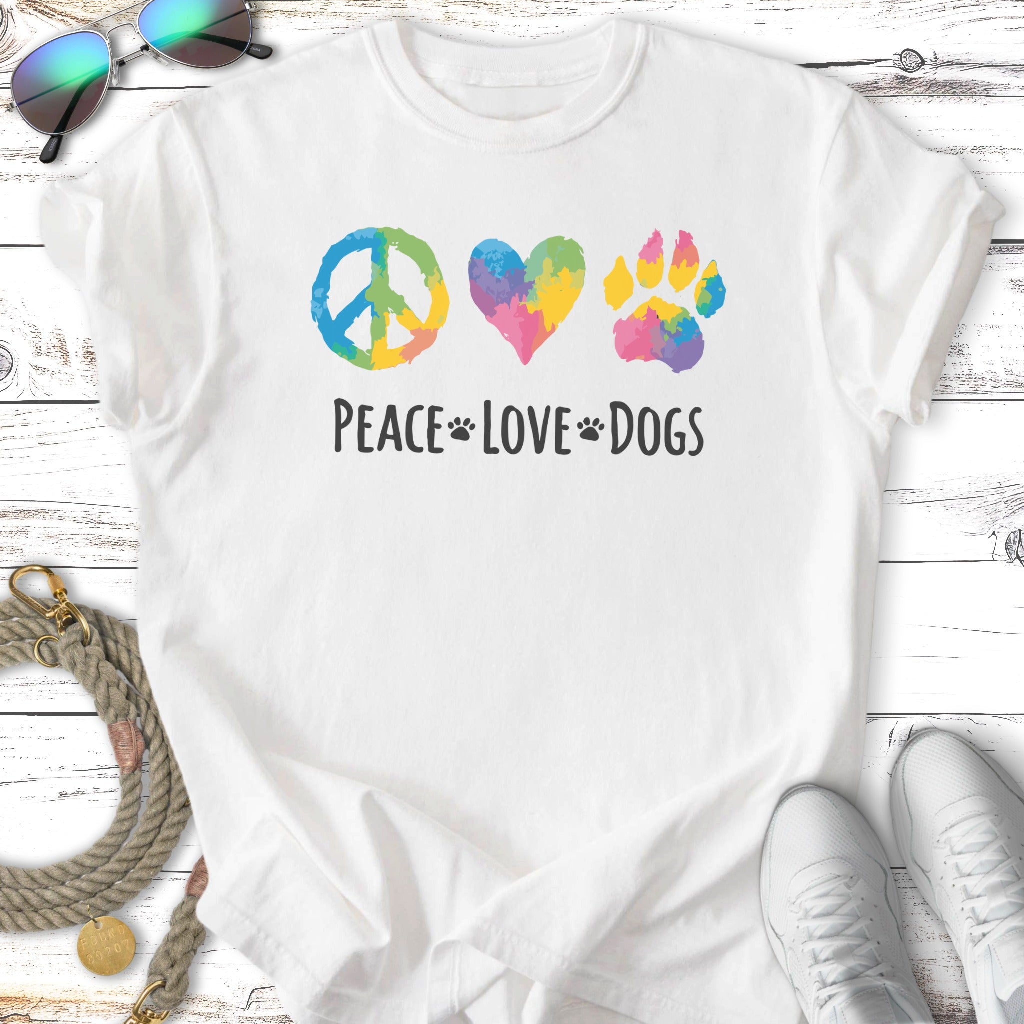 T-shirt with watercolor peace sign, heart, and paw print with "Peace Love Dogs" text.