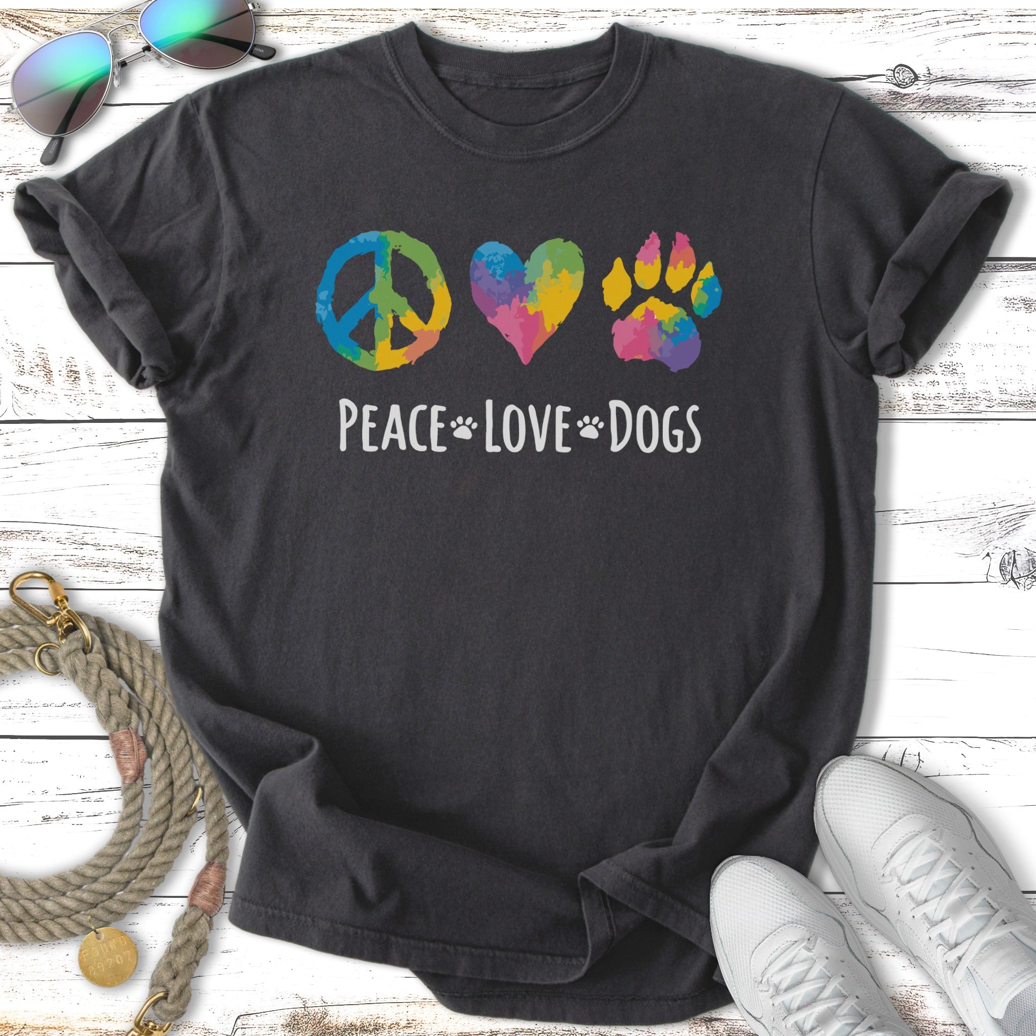 Dark t-shirt with peace sign, heart, and paw print in rainbow colors, "Peace Love Dogs" text.