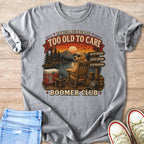 T-shirt graphic: dog in rocking chair by lake with text "Too Old To Care Boomer Club."