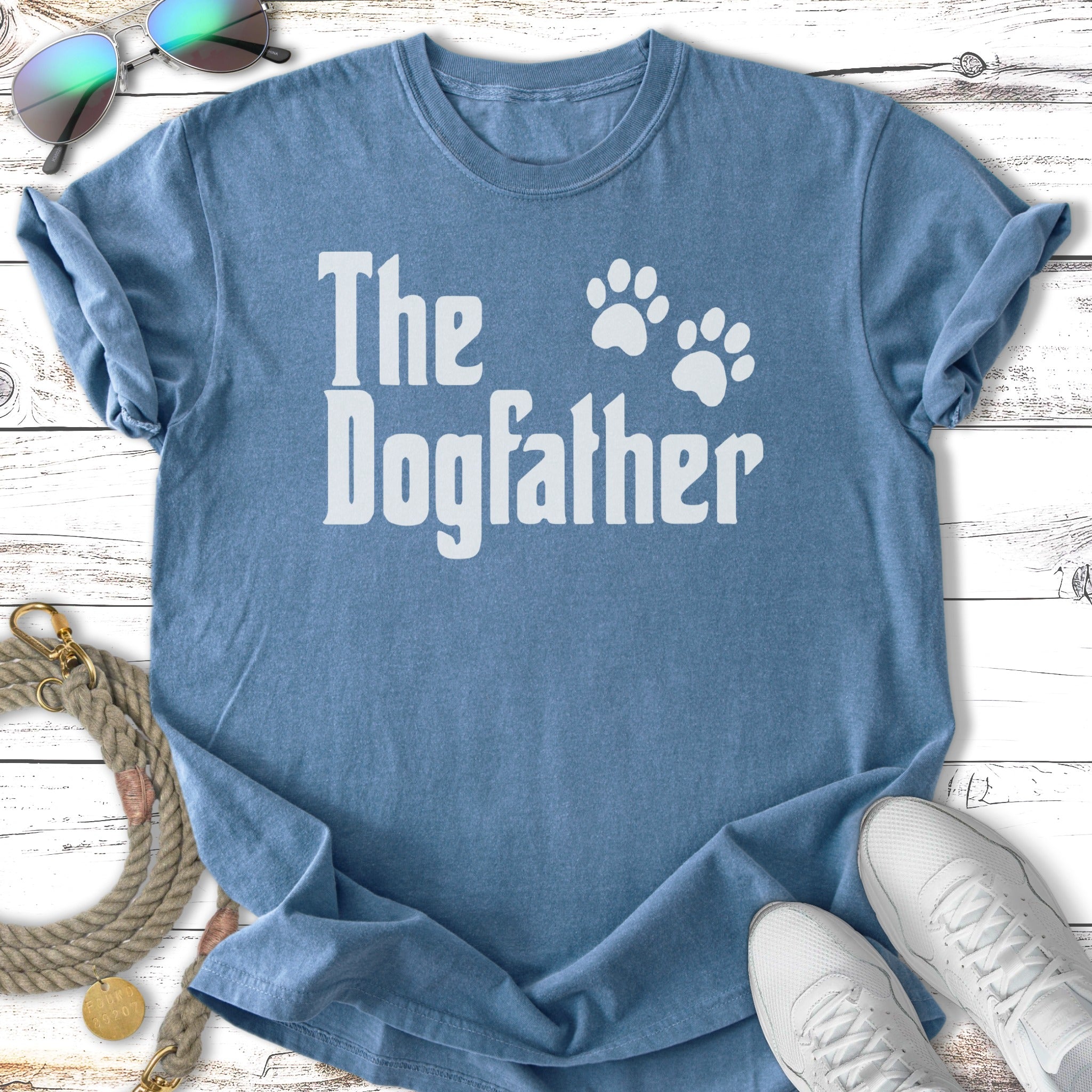 Blue t-shirt with "The Dogfather" text and paw prints.