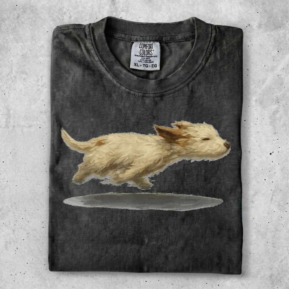 T-shirt with watercolor painting of a fluffy tan dog running.