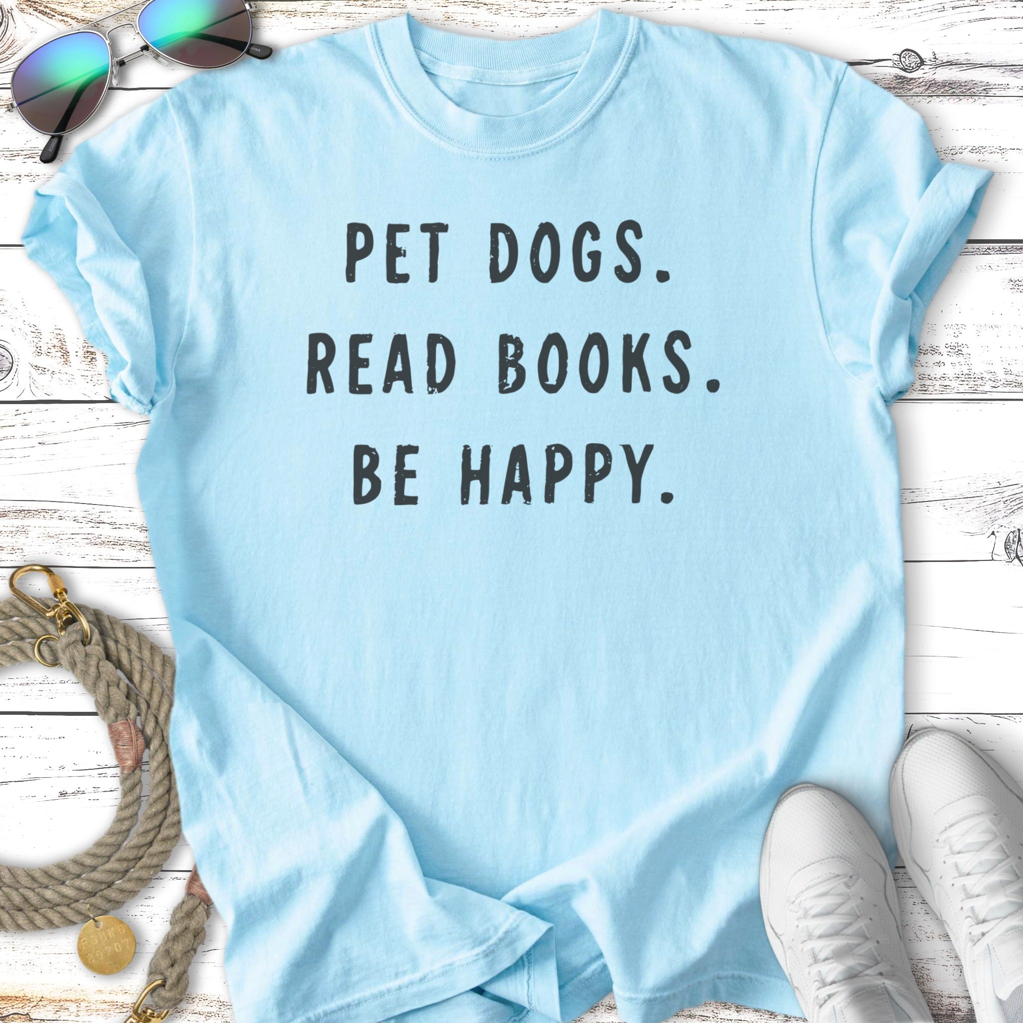Light blue t-shirt with text "PET DOGS. READ BOOKS. BE HAPPY."