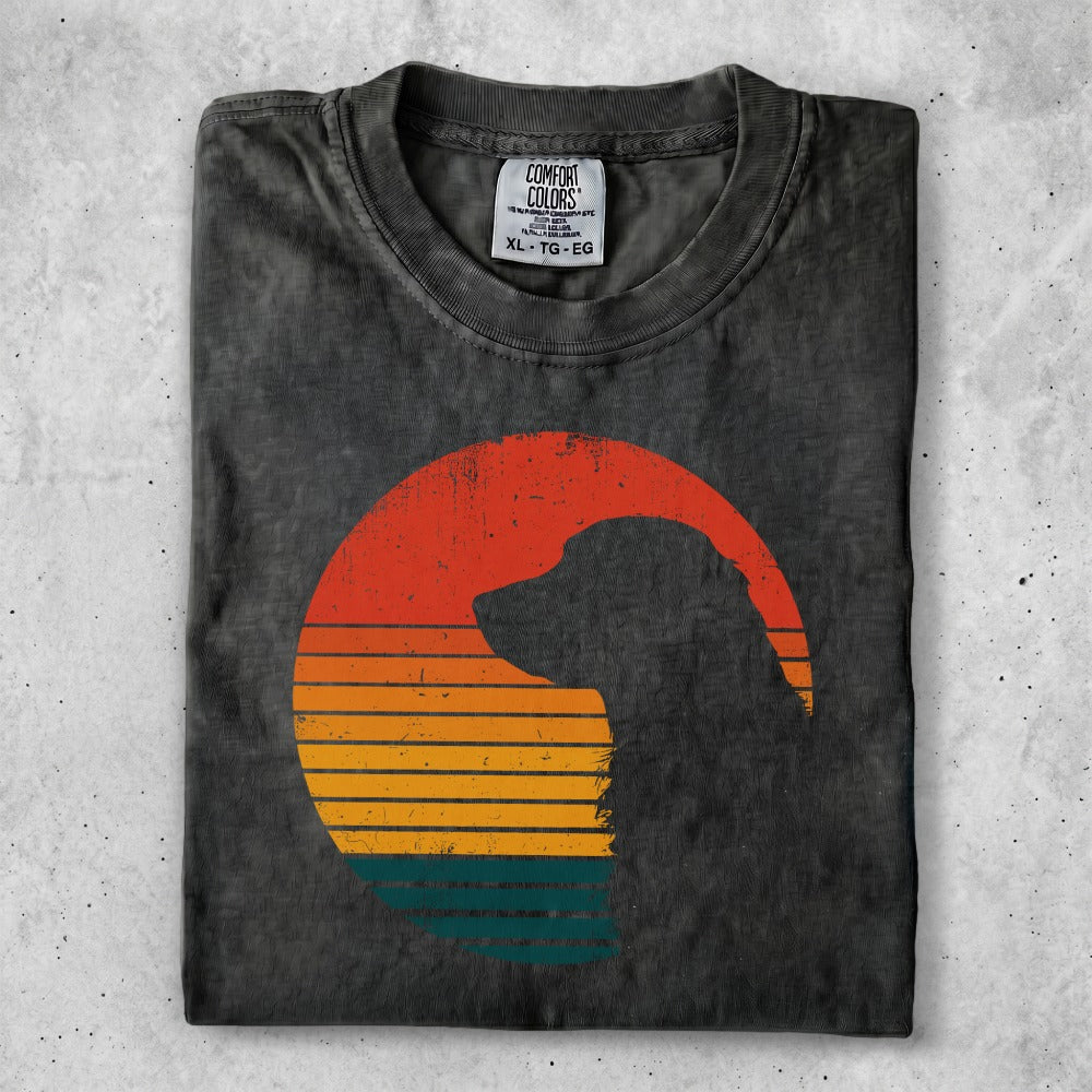 Dark t-shirt with a dog silhouette against a sunset graphic.