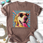 Golden retriever wearing sunglasses, tongue out, on stylized colorful background.