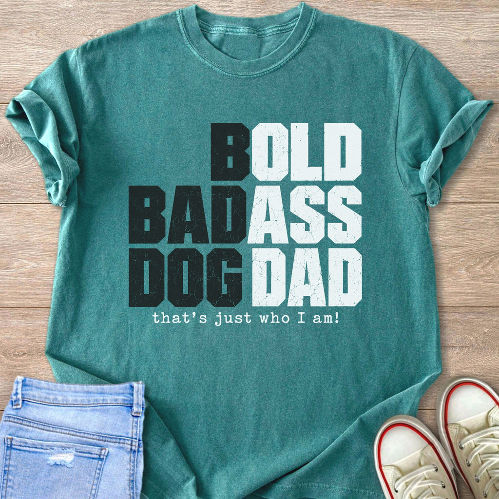 Teal t-shirt with white text "BOLD BADASS DOG DAD that's just who I am!"