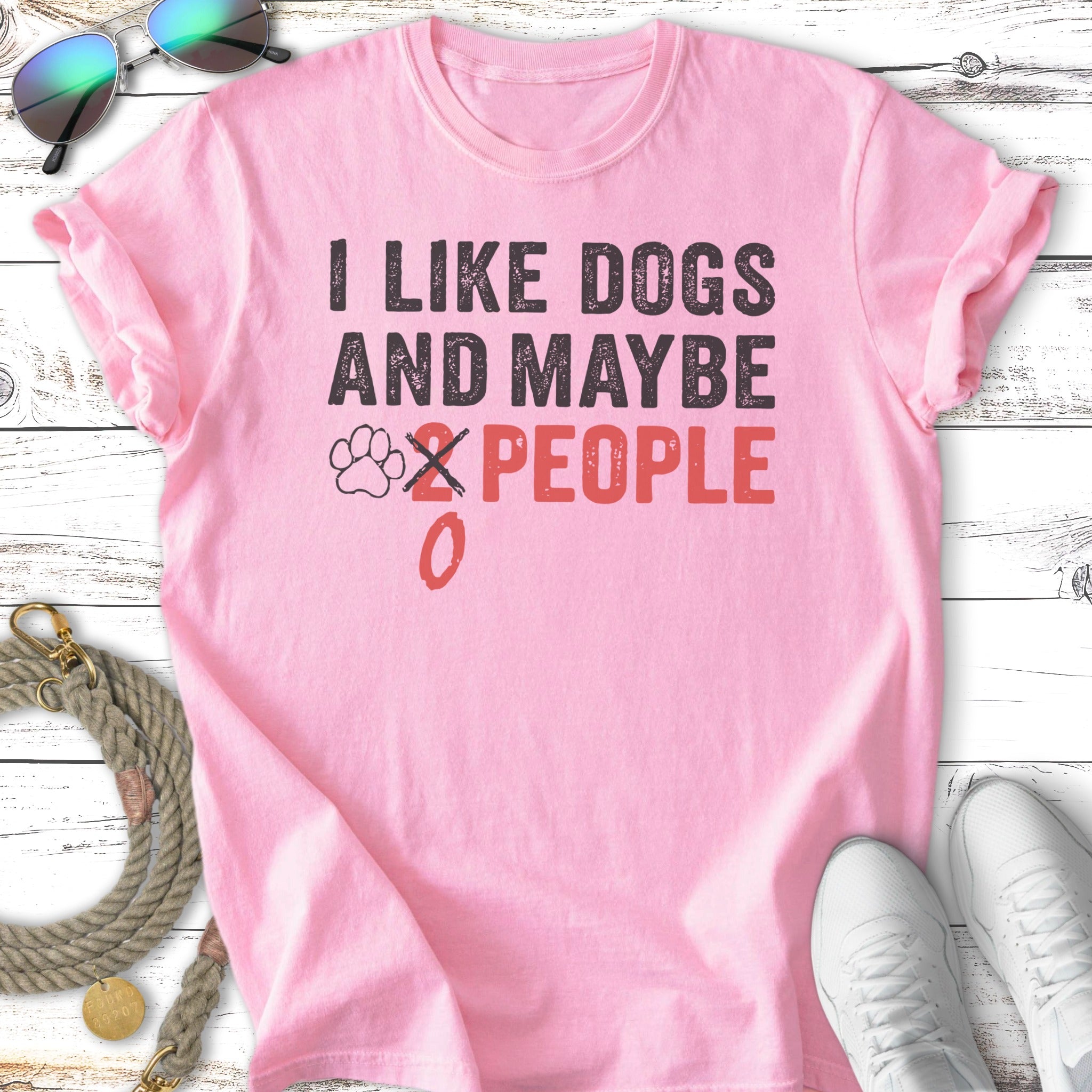 Pink t-shirt with text "I LIKE DOGS AND MAYBE 0 PEOPLE".