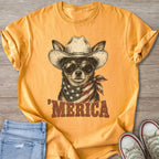 Chihuahua in cowboy hat and sunglasses with American flag bandana on yellow t-shirt.