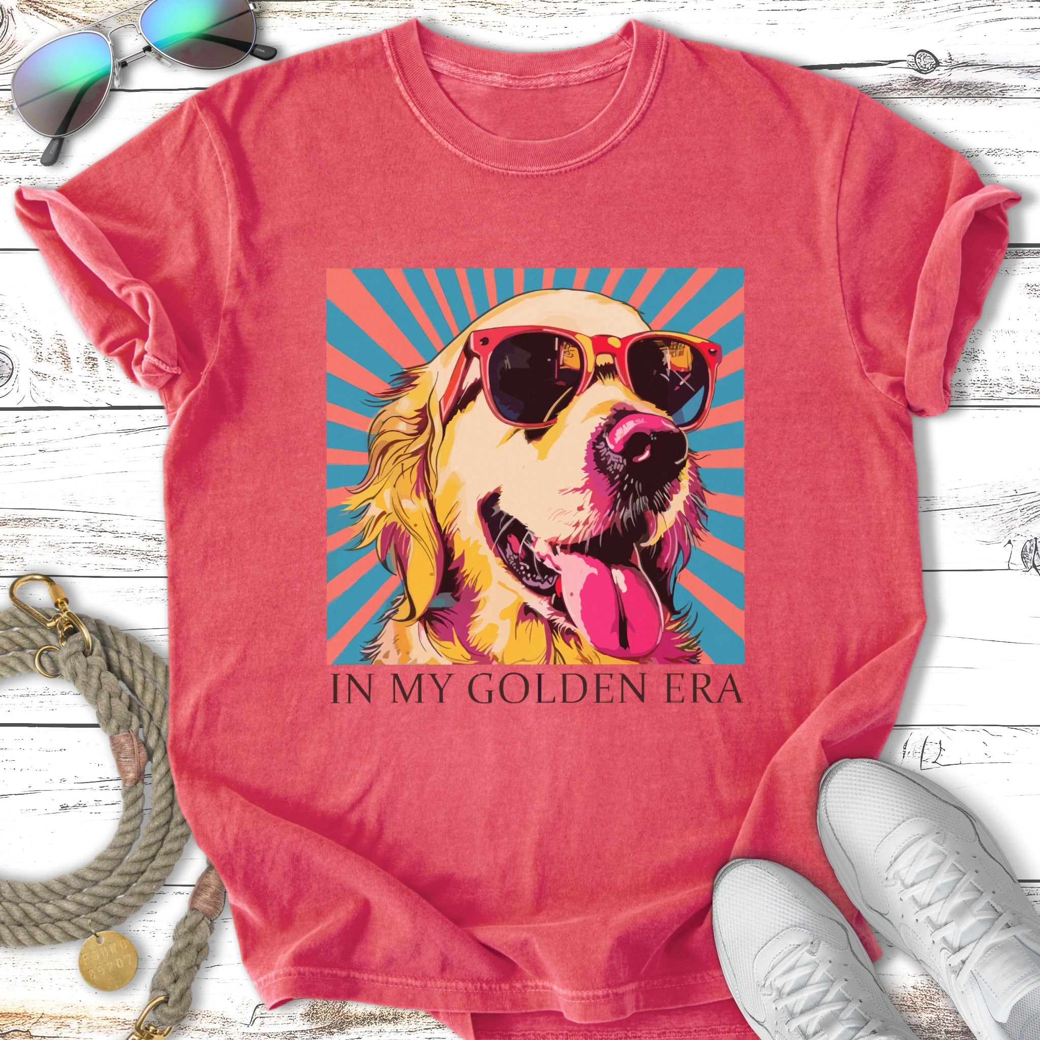 Golden retriever wearing sunglasses and a bandana, on a pink and blue background.