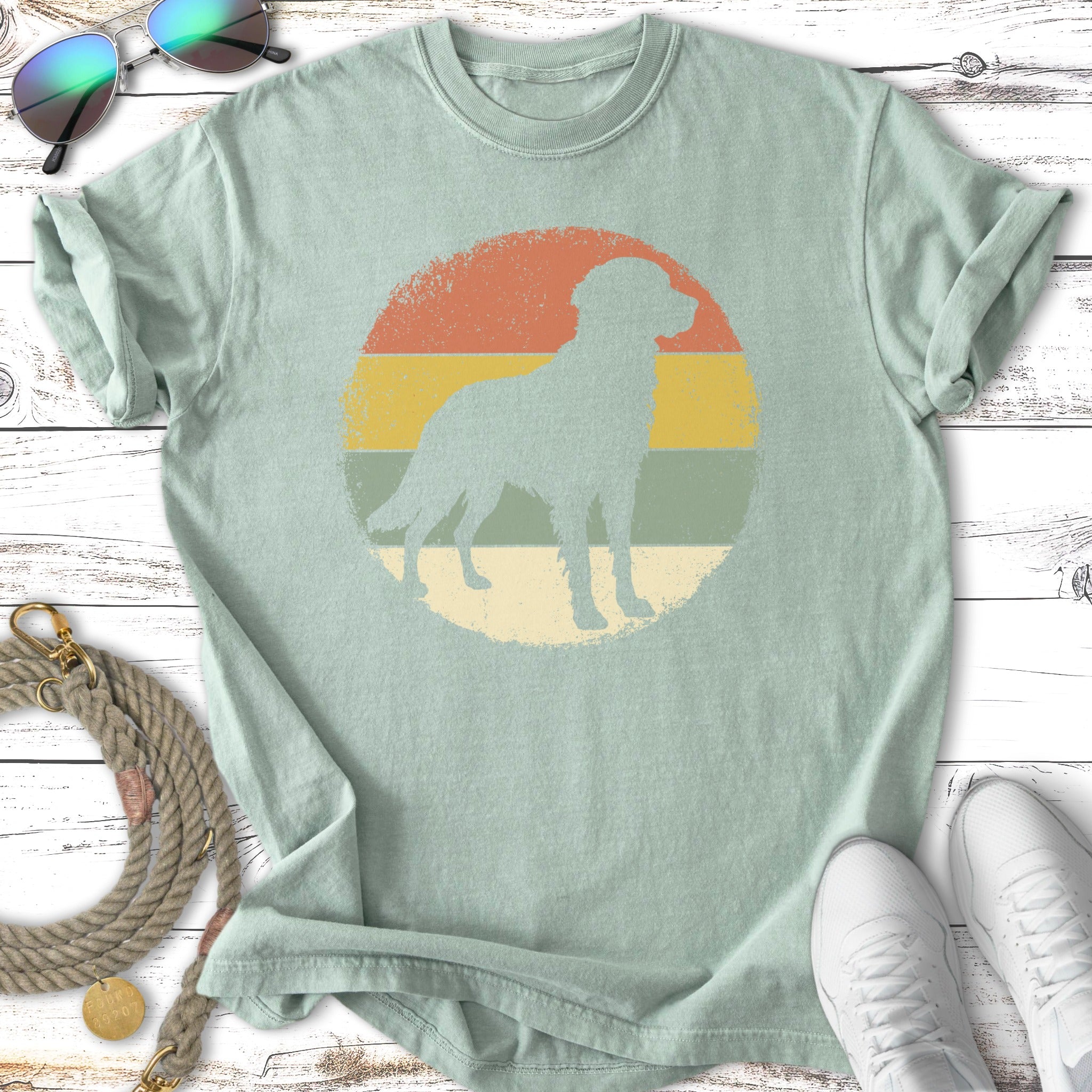 Mint green t-shirt with a dog silhouette in a vintage sunset graphic.