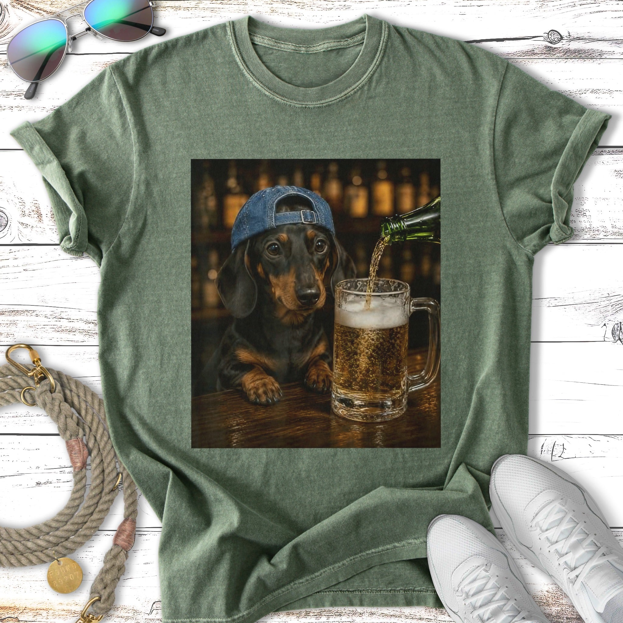 Dachshund wearing a baseball cap drinks beer from a mug in a bar.