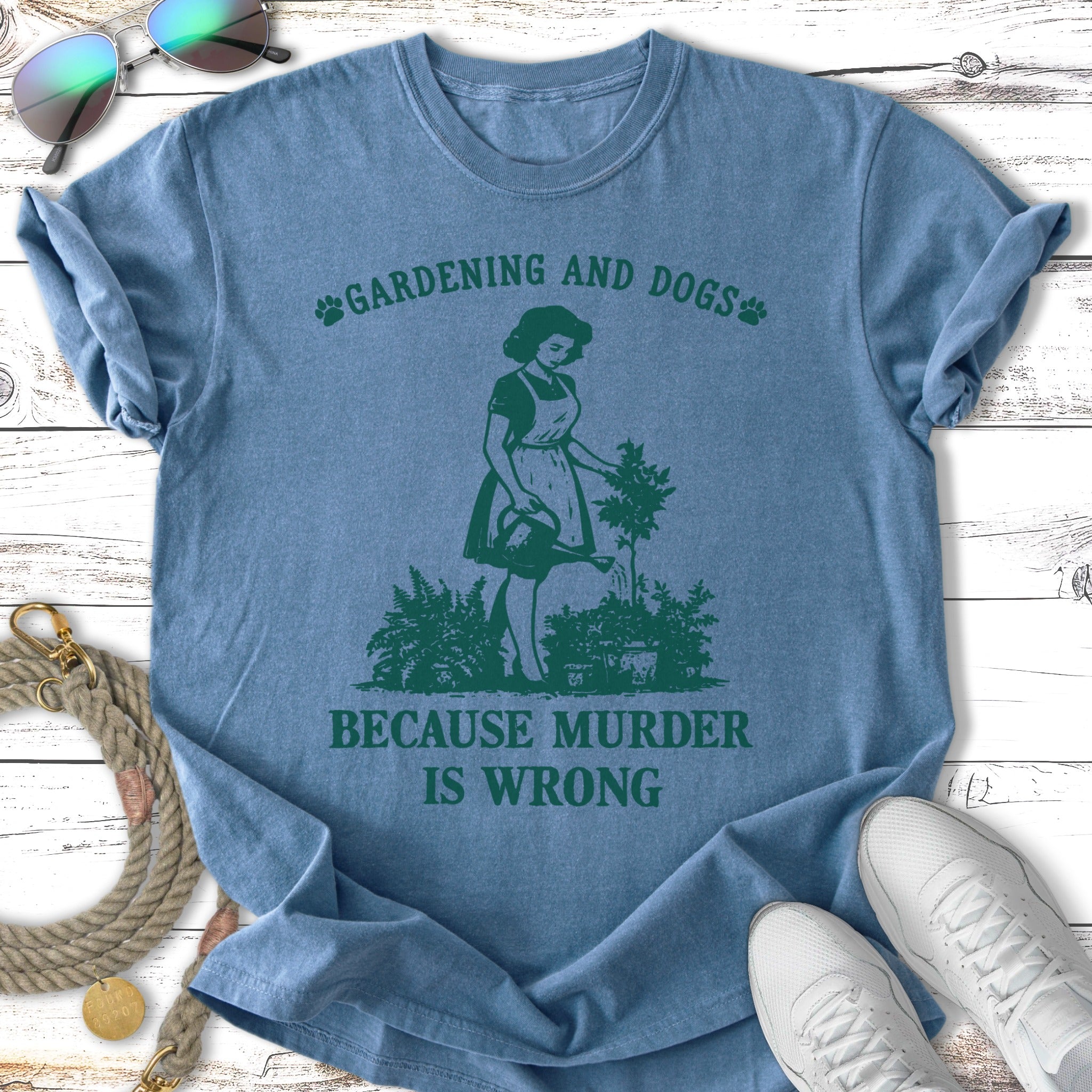 Blue t-shirt with "Gardening and Dogs, Because Murder Is Wrong" and a gardening silhouette.