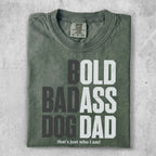 Green t-shirt with "BOLD BADASS DOG DAD" and "that's just who I am!" text.