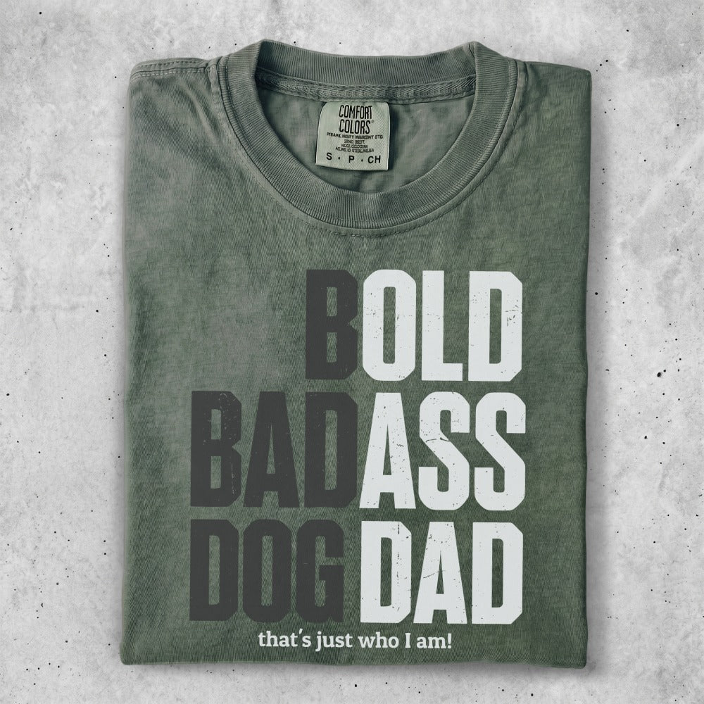Green t-shirt with "BOLD BADASS DOG DAD" and "that's just who I am!" text.