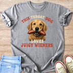 Golden retriever dog with sausage in mouth and text: This throat dog loves juicy wieners.