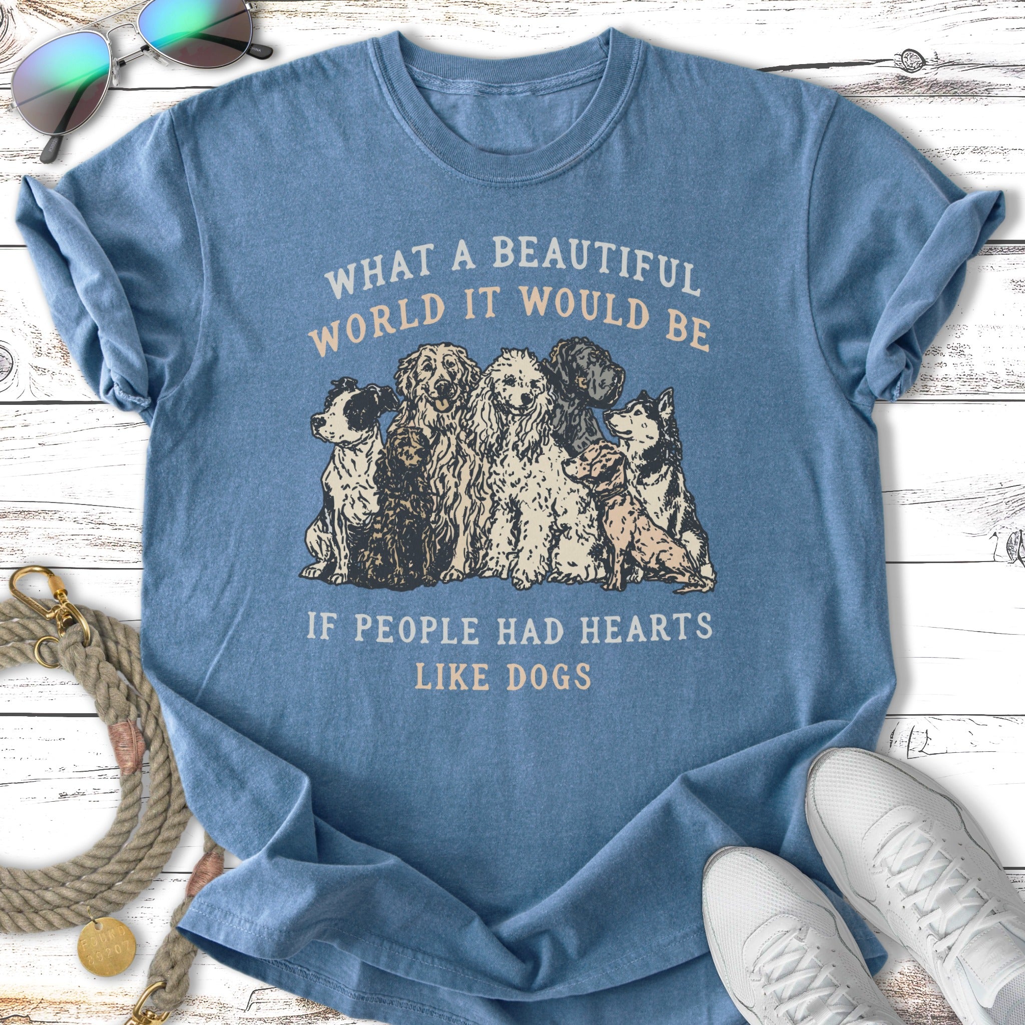 Blue t-shirt with dogs and text: "What a beautiful world it would be if people had hearts like dogs."