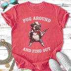 T-shirt with a pug in a cowboy hat holding a gun, text "Pug Around And Find Out."