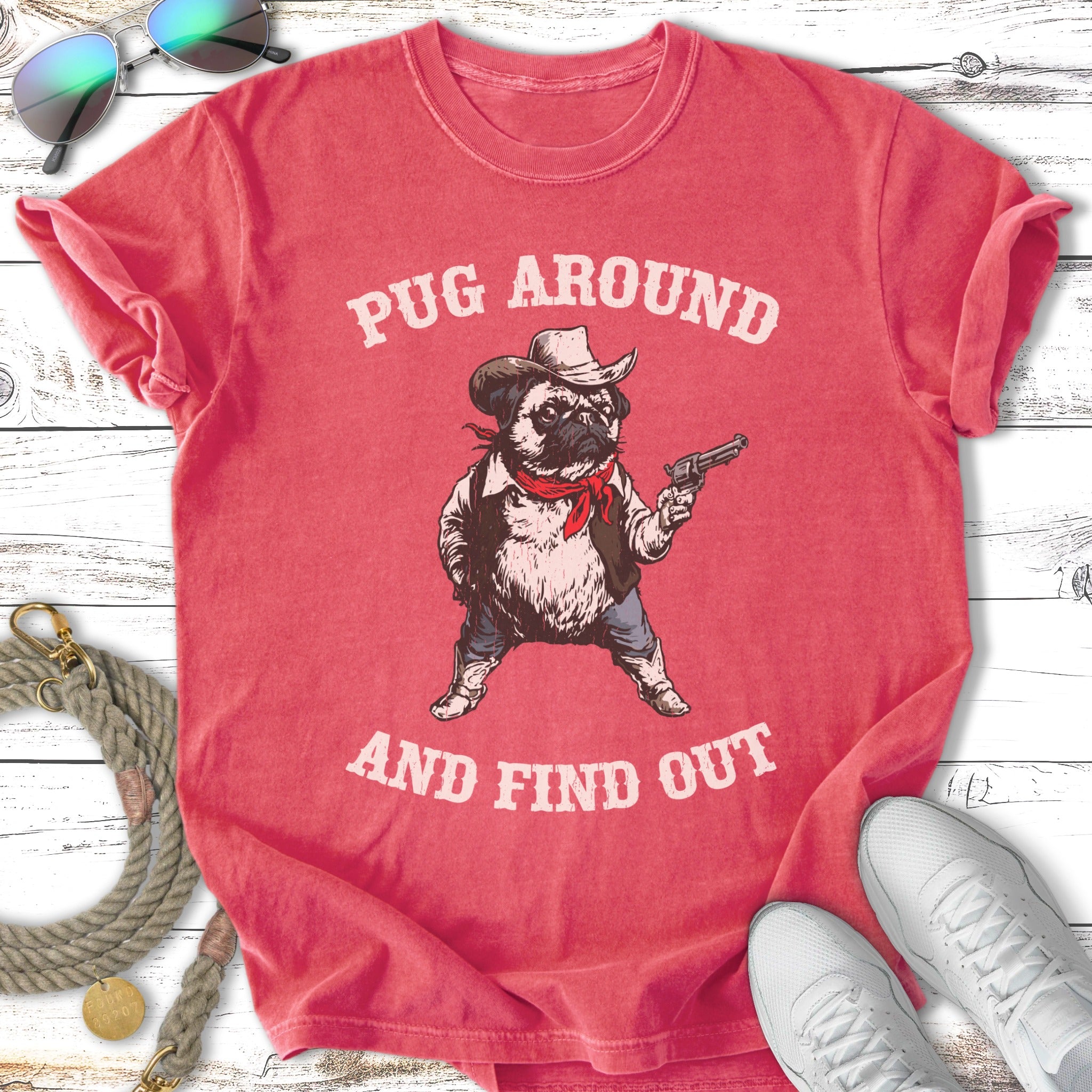 T-shirt with a pug in a cowboy hat holding a gun, text "Pug Around And Find Out."