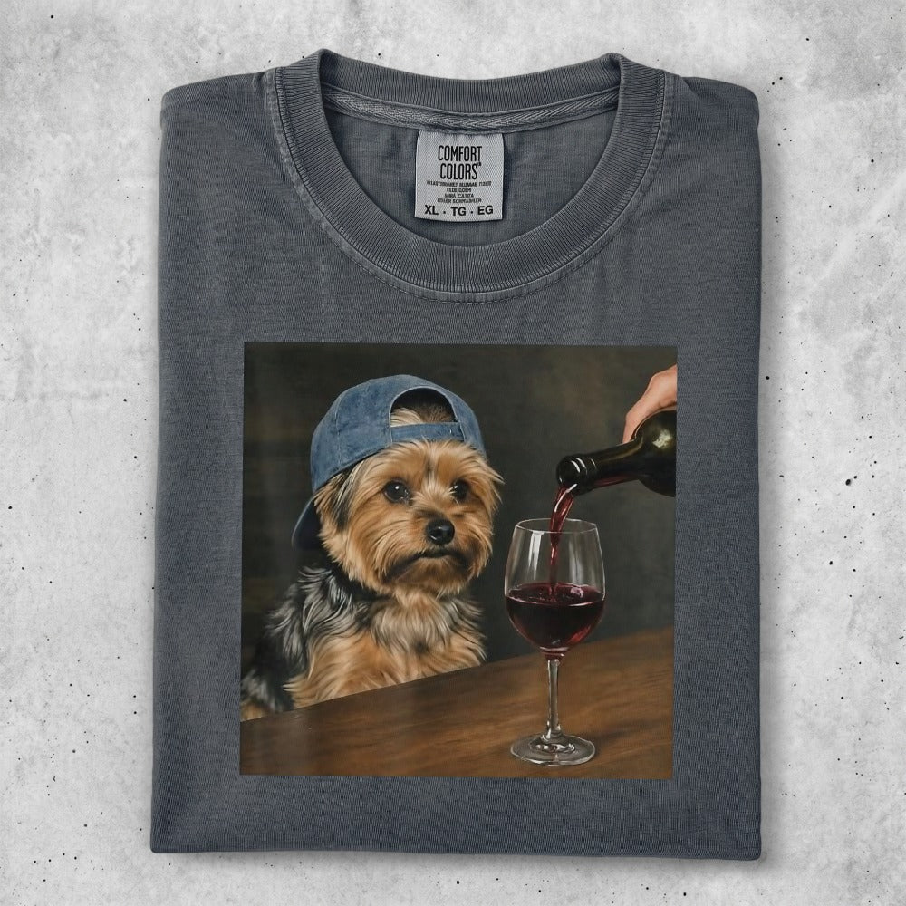T-shirt with a painting of a dog wearing a baseball cap, pouring red wine.