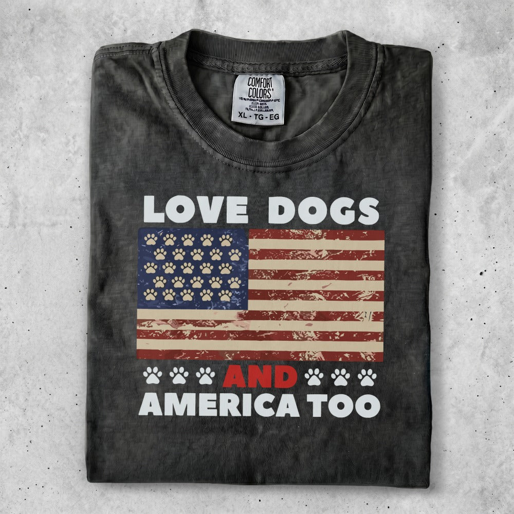 Black t-shirt with "LOVE DOGS AND AMERICA TOO" and an American flag with paw prints.