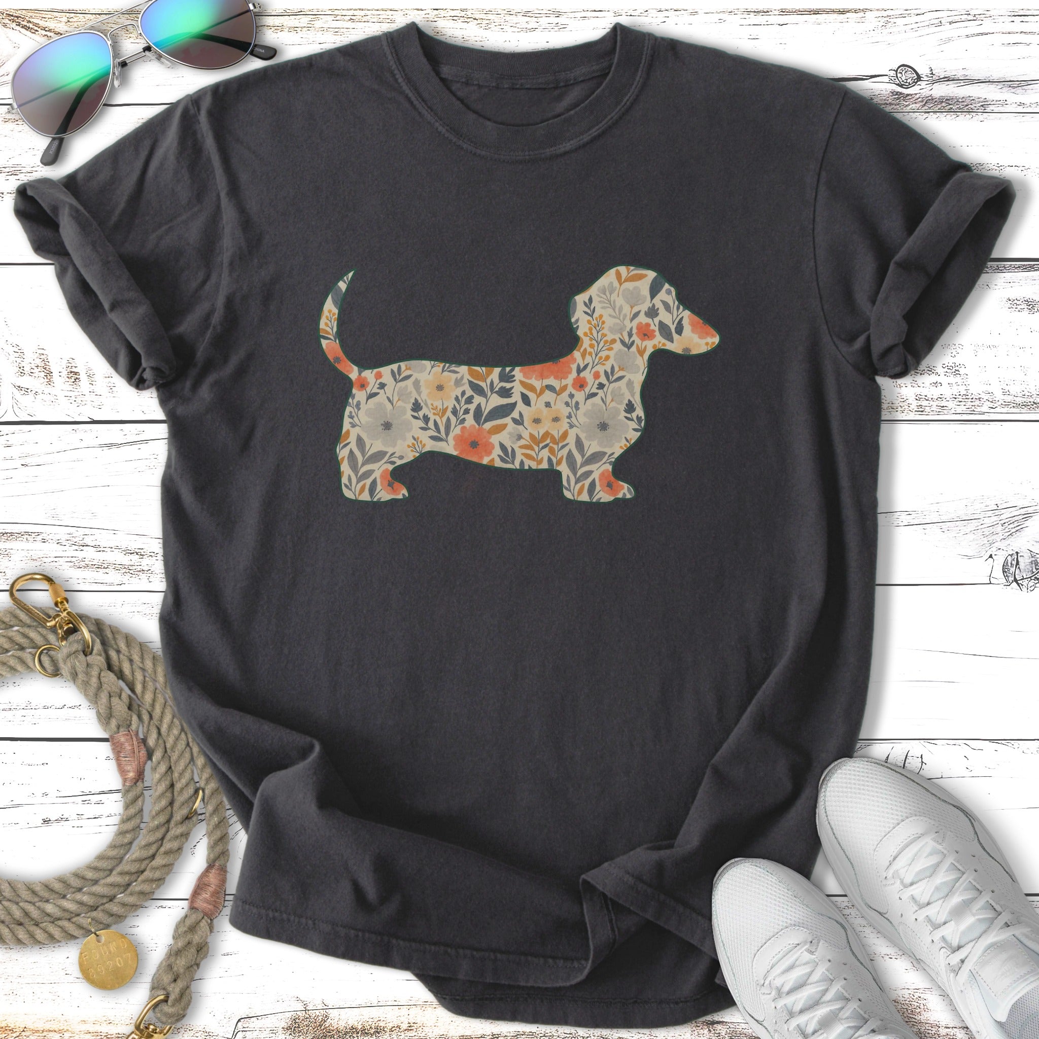 Dark t-shirt with a silhouette of a dachshund filled with a floral pattern.