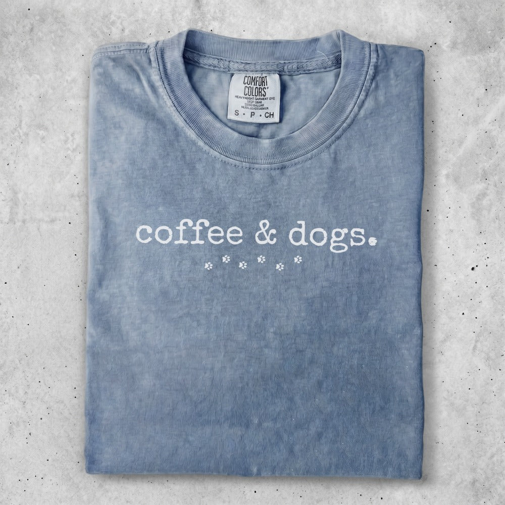 Blue t-shirt with "coffee & dogs." graphic.