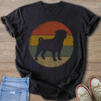 Dark t-shirt with a black pug silhouette within a distressed circular sunset graphic.