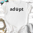 White t-shirt with "adopt" text and paw print.