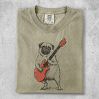 Pug playing a red electric guitar, Comfort Colors tag visible.