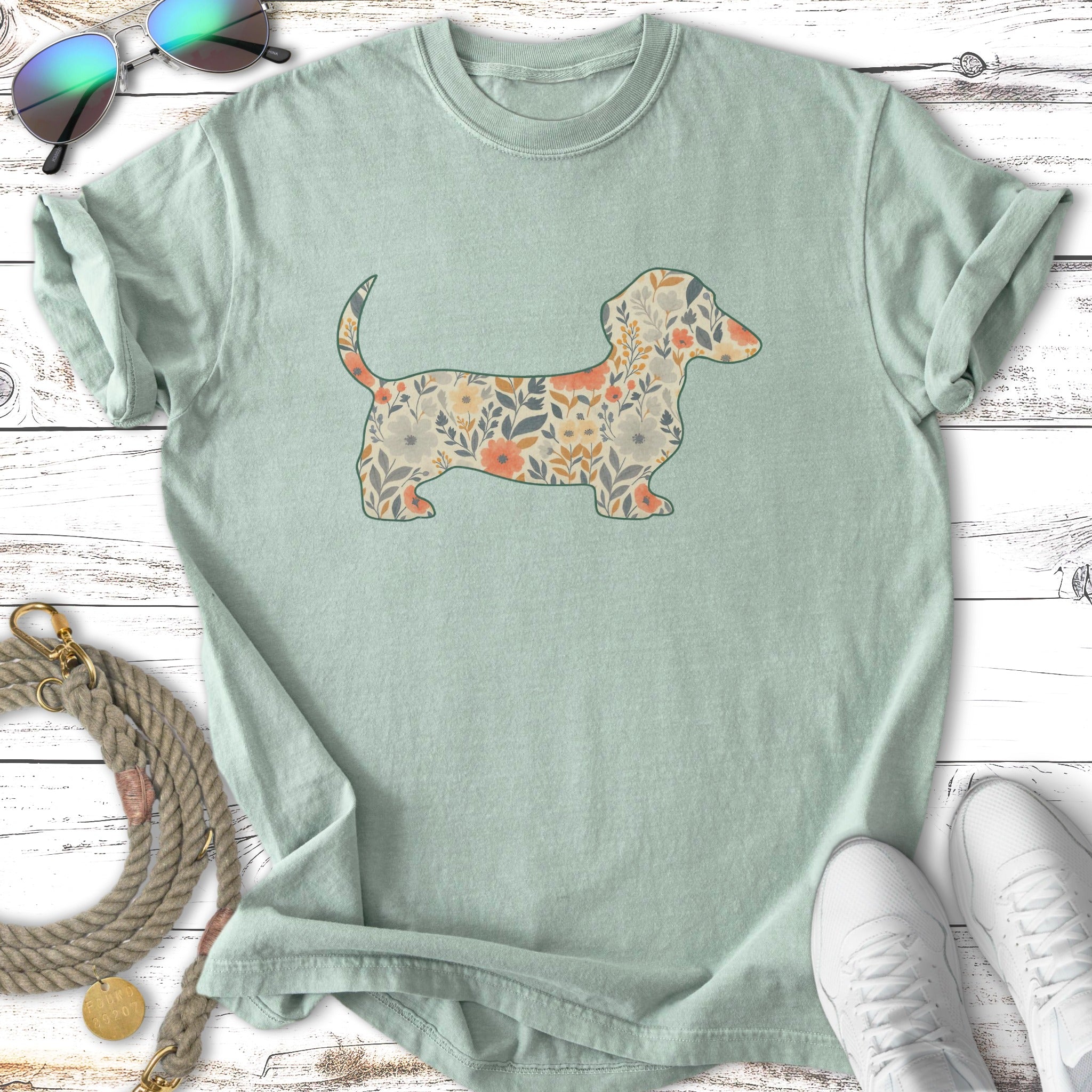 Light green t-shirt with a dachshund silhouette filled with a floral pattern.