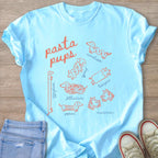 Light blue t-shirt with orange "pasta pups" text and various pasta-shaped dogs.