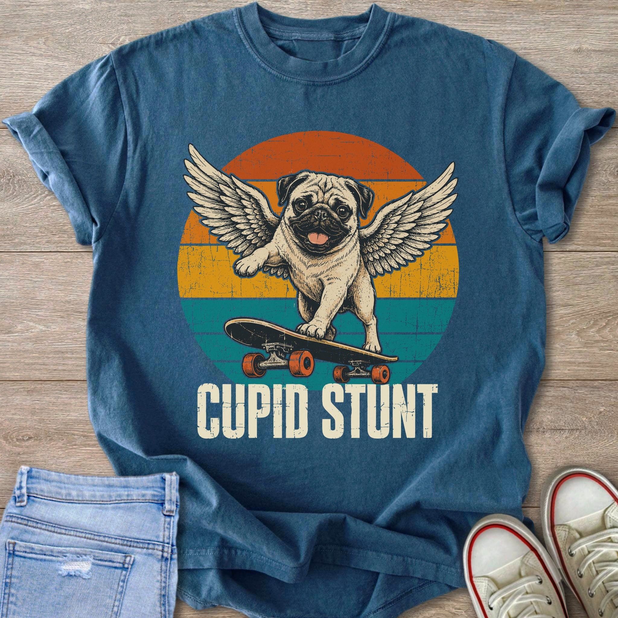 Pug with wings skateboarding in front of distressed sunset, text "CUPID STUNT".