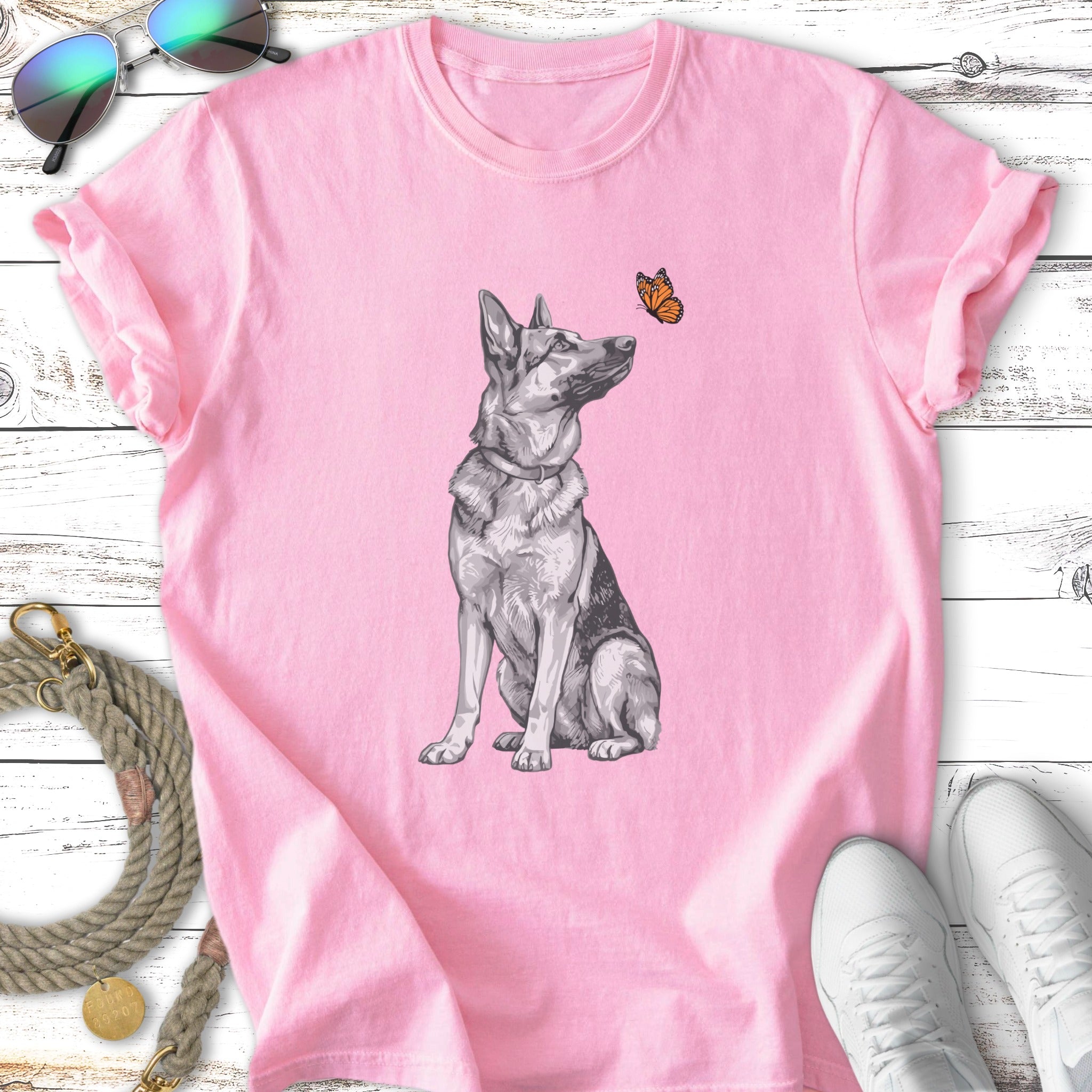 German Shepherd sitting with a butterfly above its head.