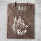 Brown t-shirt with a graphic of a French bulldog sniffing a dandelion.
