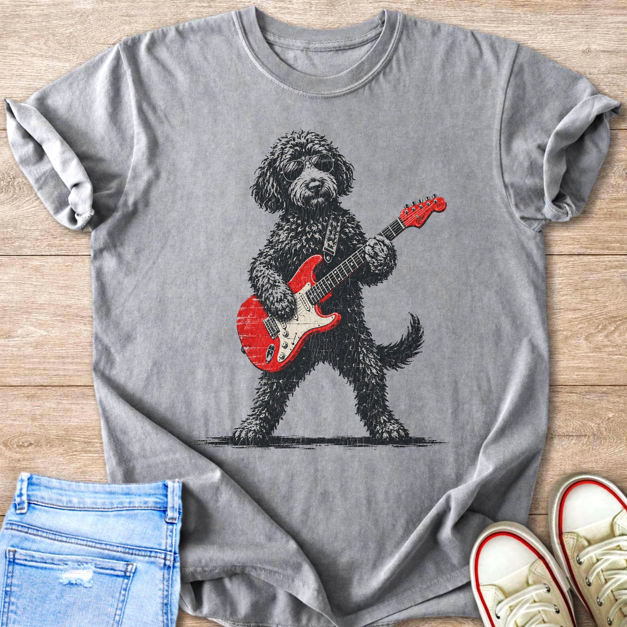Fluffy black dog wearing sunglasses playing a red electric guitar.