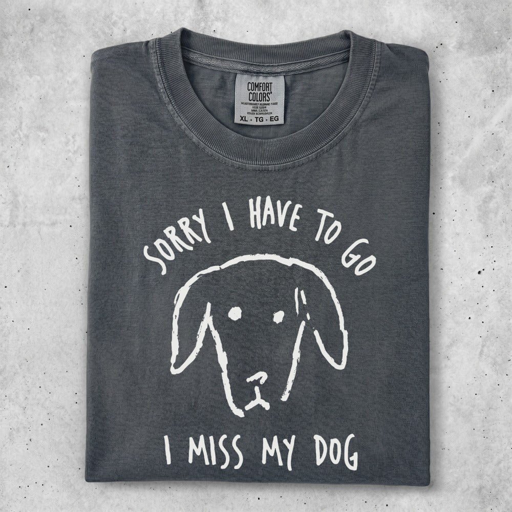 Gray t-shirt with a white line drawing of a dog's face and text "SORRY I HAVE TO GO I MISS MY DOG".