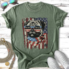 Pug wearing American flag sunglasses and bandana on green t-shirt.
