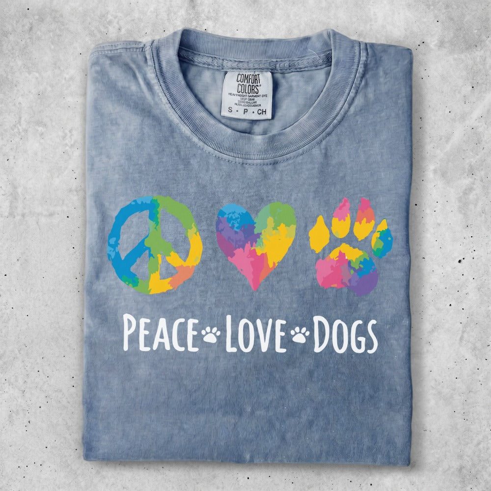 Peace, love, and paw print design on a blue t-shirt.