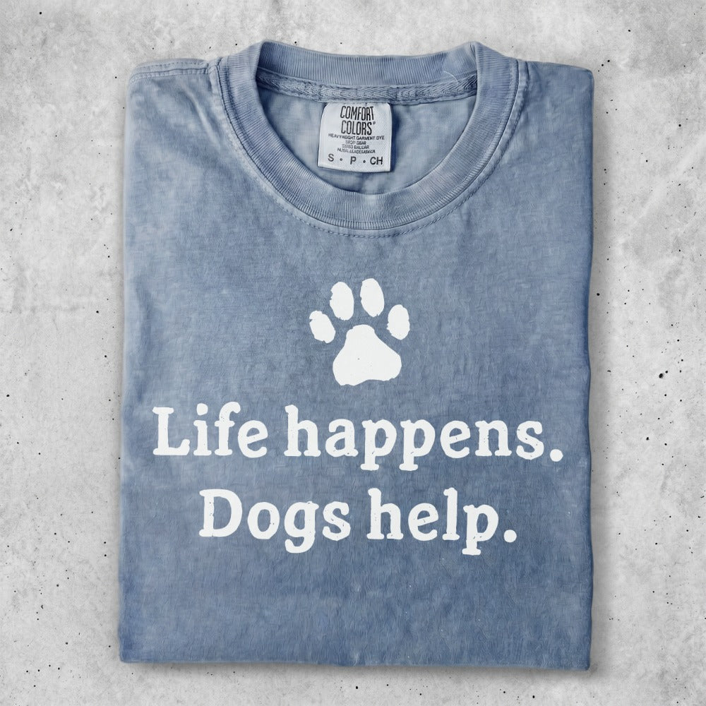 Blue t-shirt with white text: "Life happens. Dogs help." and a paw print.