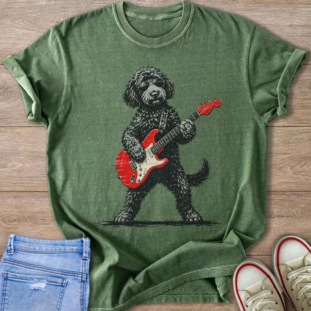 Green t-shirt with graphic of a shaggy dog wearing sunglasses playing a red electric guitar.