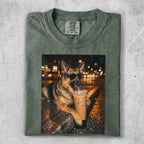 German Shepherd wearing sunglasses drinks iced coffee by a wet street.