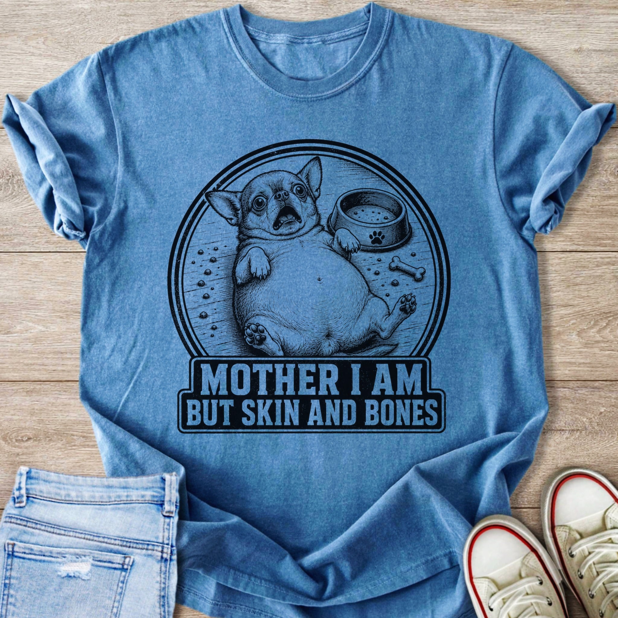 Blue t-shirt with a distressed graphic of a chonk chihuahua and the text "MOTHER I AM BUT SKIN AND BONES".