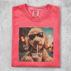 T-shirt with a doodle dog wearing sunglasses drinking from a cup.