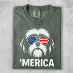 Green t-shirt with a white dog wearing American flag sunglasses and the word 'Merica.