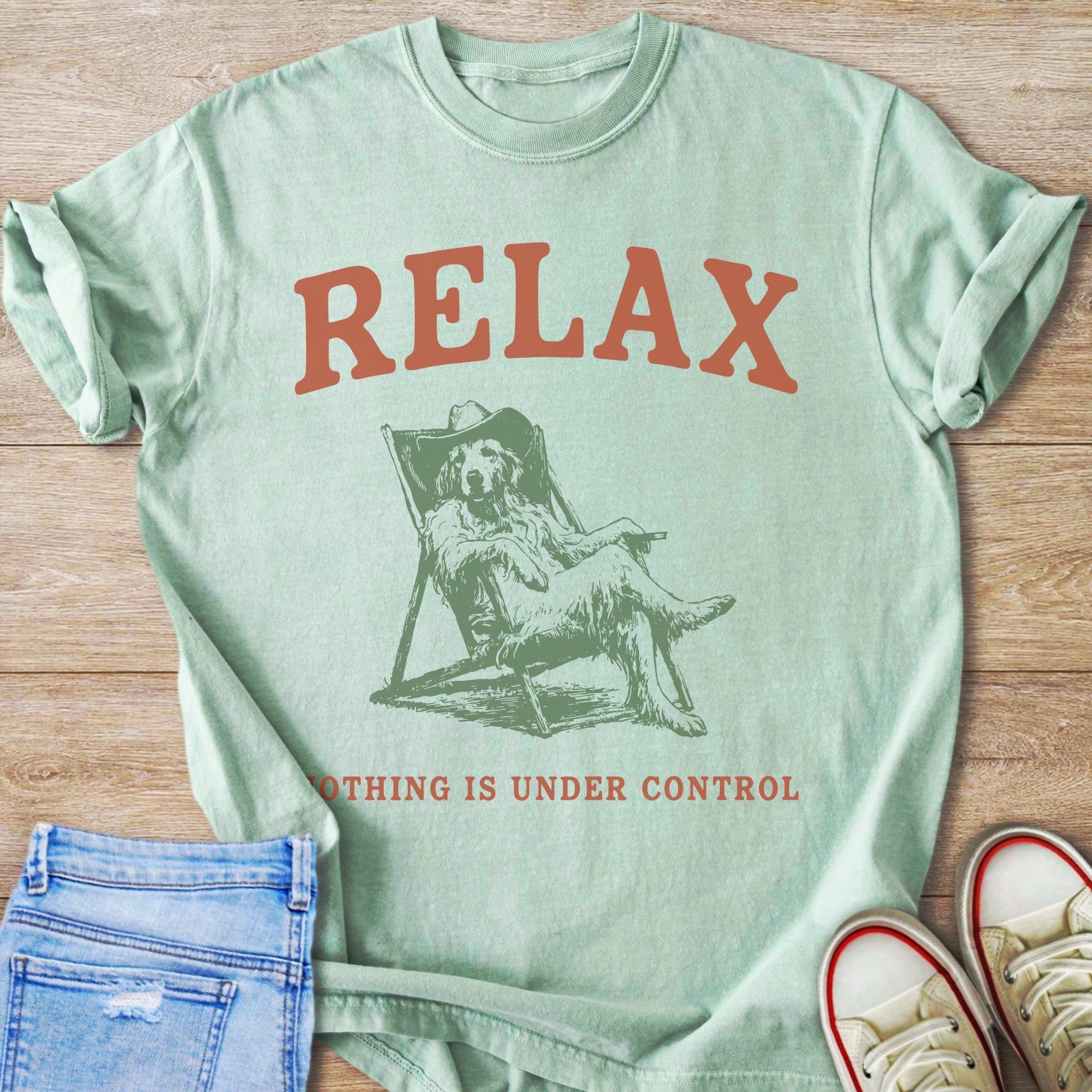 Light green t-shirt with "RELAX" and a dog in a chair graphic.