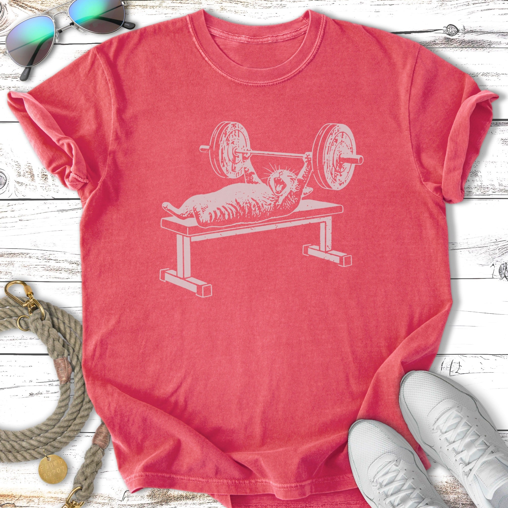Pink t-shirt with distressed graphic of a cat lifting weights.