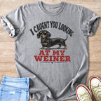 Gray t-shirt with a dachshund graphic and text "I CAUGHT YOU LOOKING AT MY WEINER".