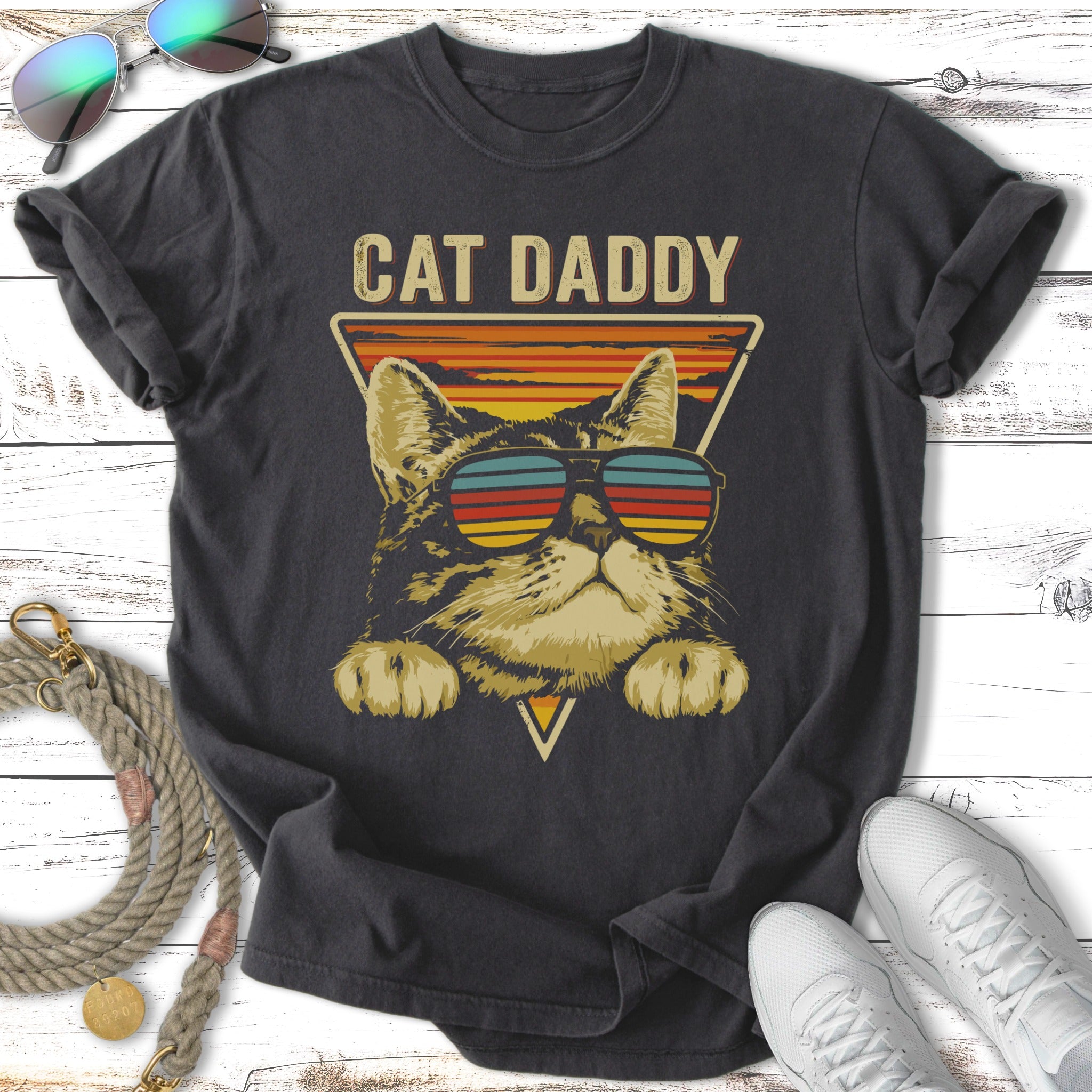 Cat Daddy graphic tee with striped sunglasses on a tabby cat.