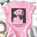 Pink t-shirt with black graphic of a dog and text "because therapy is expensive."