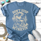 Blue t-shirt with vintage distressed Golden Retriever wearing sunglasses and text "Don't Stop Retrieving".